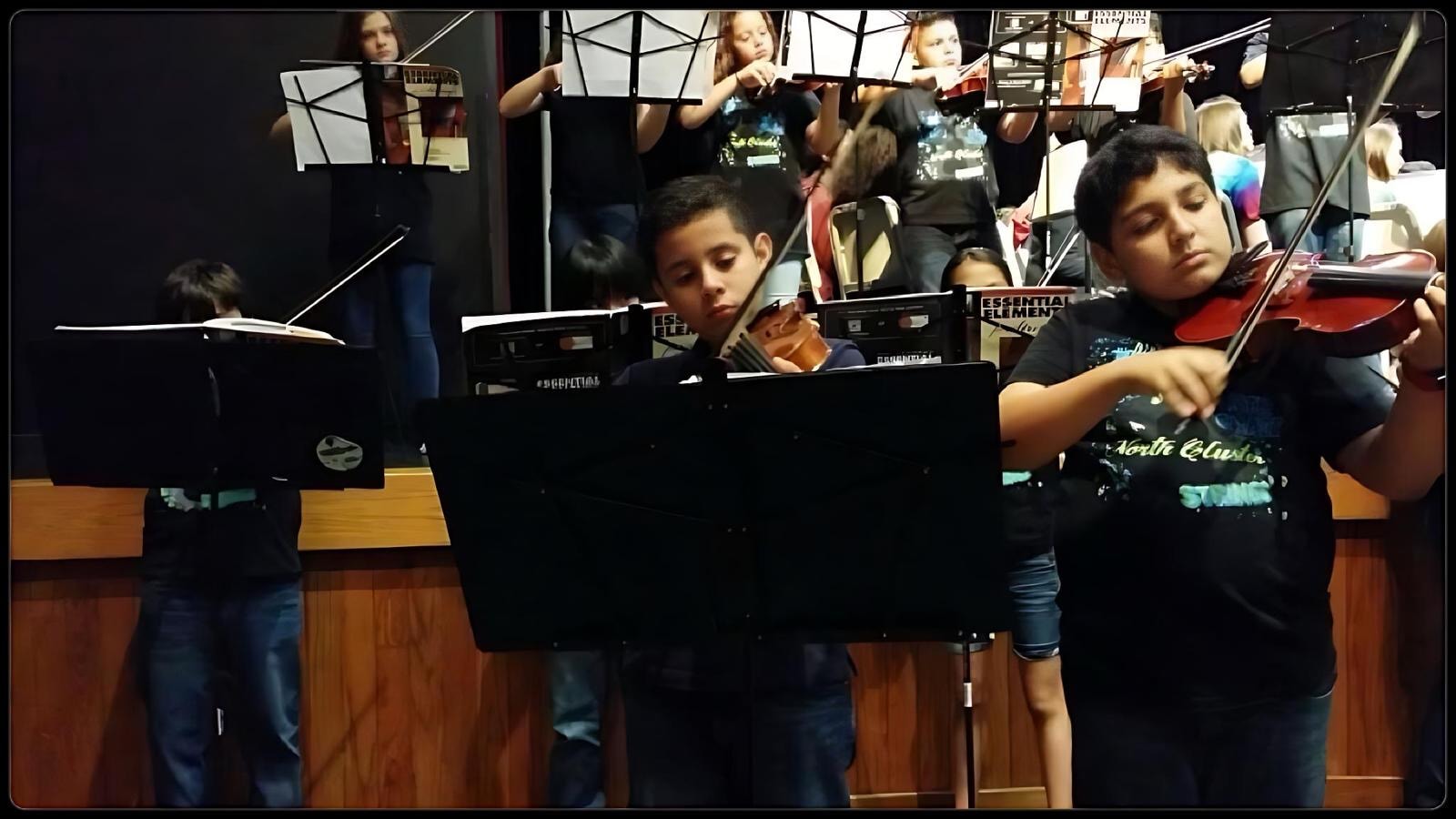 Daniel performing viola in school ensemble